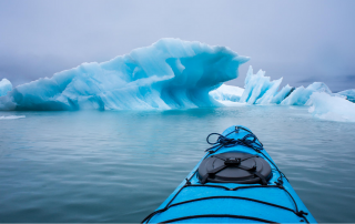 Kayaking Near An Iceberg