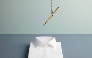 An Ink Pen Dangling over a spotless white shirt | In Anxious Anticipation Aaron Tilley