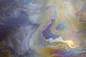 A mixture of hydrocarbon monomers, here represented depressingly by oil pollution in the sea. huyangshu-Shutterstock