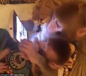 The older 'father' monkey can be seen scrolling through the tablet 2