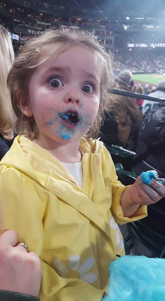 cute 3-year old making faces after eating cotton candy
